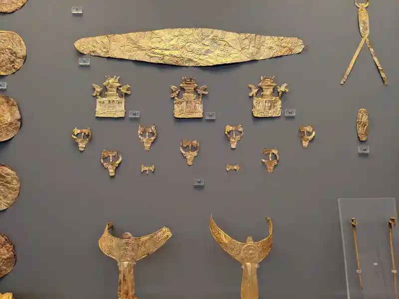Gold bull-head ornaments crowned with double axes from Grave IV, Mycenae